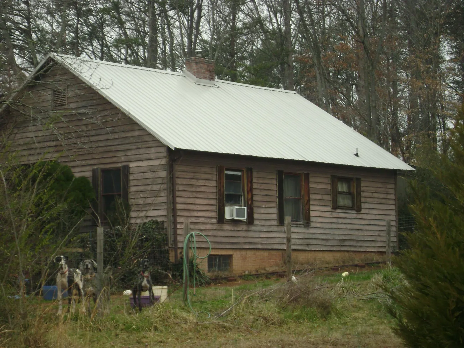 White metal roof on an old wood sided farmhouse, from a Asphalt Shingle Roof Repair job in Buffalo Valley